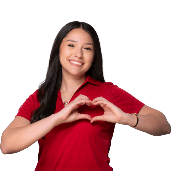 Employee smiling and forming heart shape with hands.