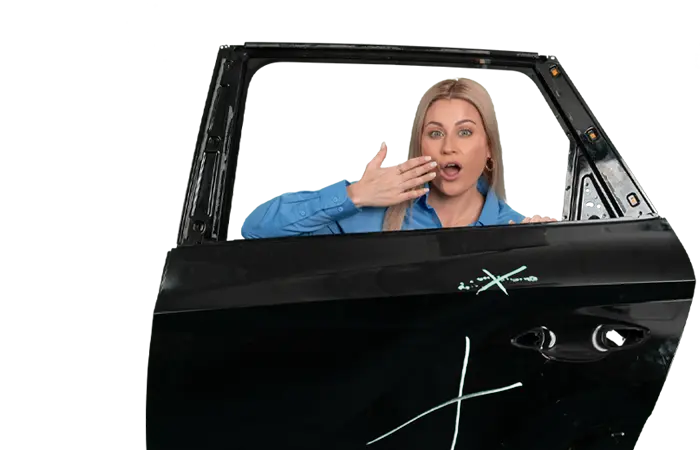 surprised Red McCombs Automotive Group employee looking through a damaged car door window with visible collision markings