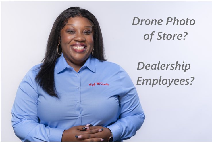Red McCombs Automotive Group Employee smiling in uniform against light background
